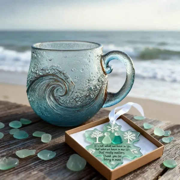 Ocean Wave Glass Mug on a driftwood table at the beach with sea glass
